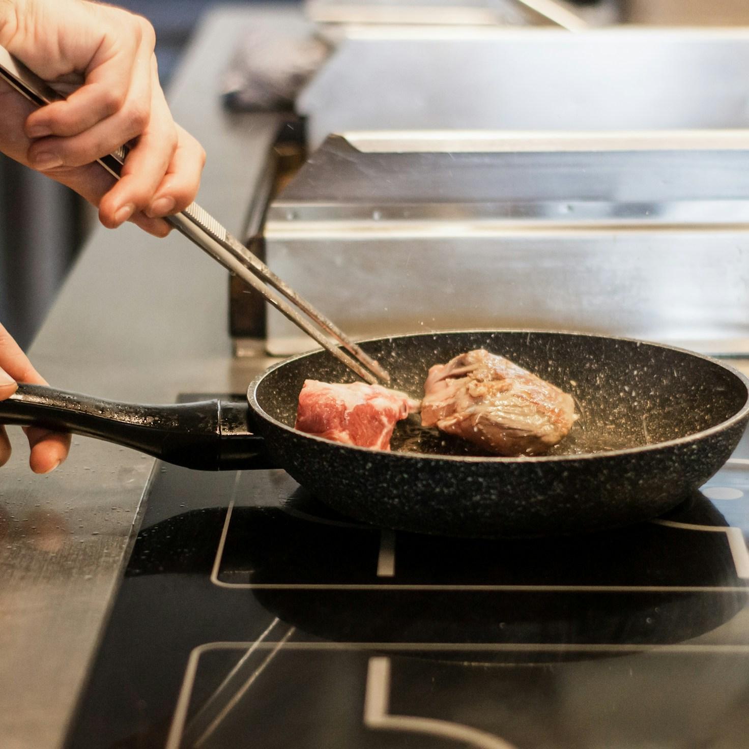 Community members collaborating in a modern kitchen space, sharing recipes and cooking techniques